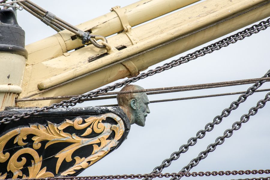 A carved wooden figurehead on a tall ship at Mystic Seaport in Connecticut.