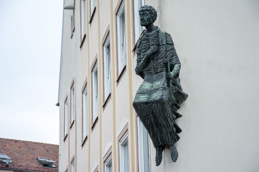 A statue on the side of a building in Nuremberg, Germany.