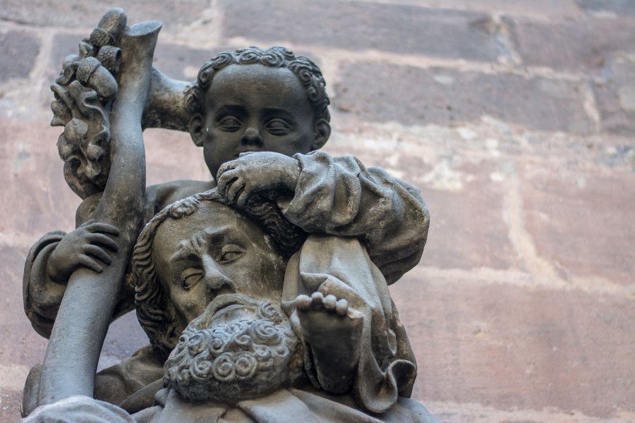 Man and child stone sculpture at Germanisches Nationalmuseum in Nuremberg, Germany.