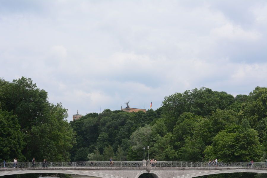 Maximilianeum seen just behind the trees from the bridge over Isar River in Munich, Germany.