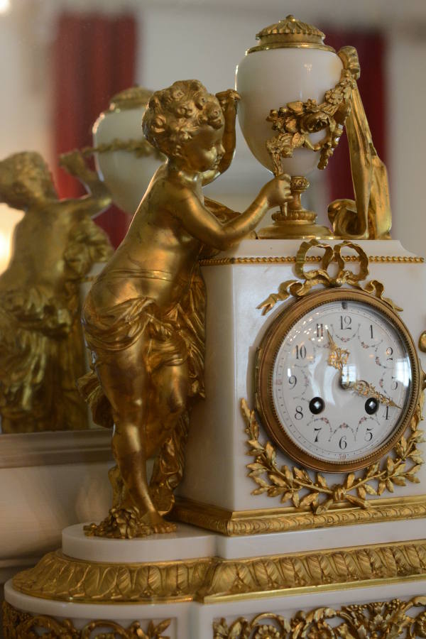 An antique gilded clock at Nemours Mansion.