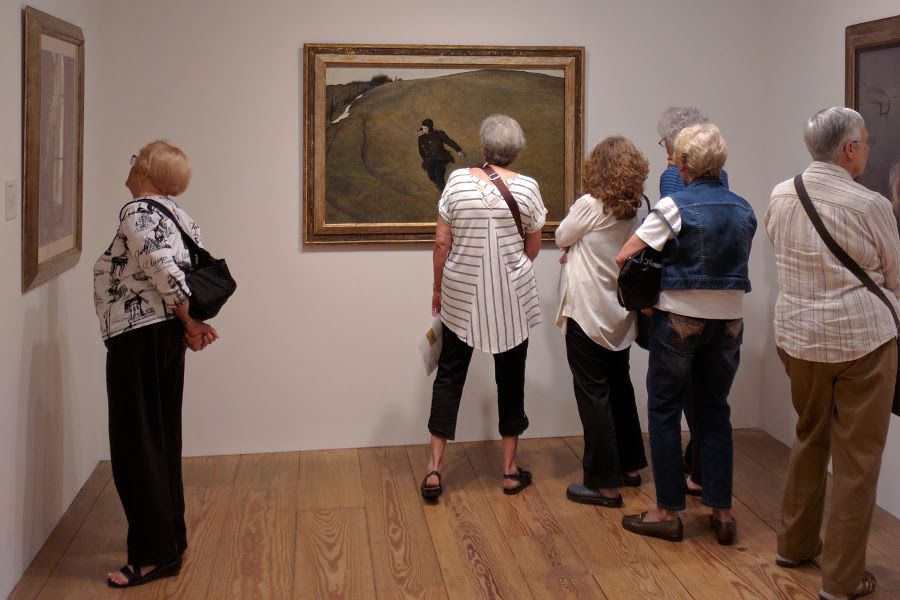 Visitors examining Andrew Wyeth's Winter.