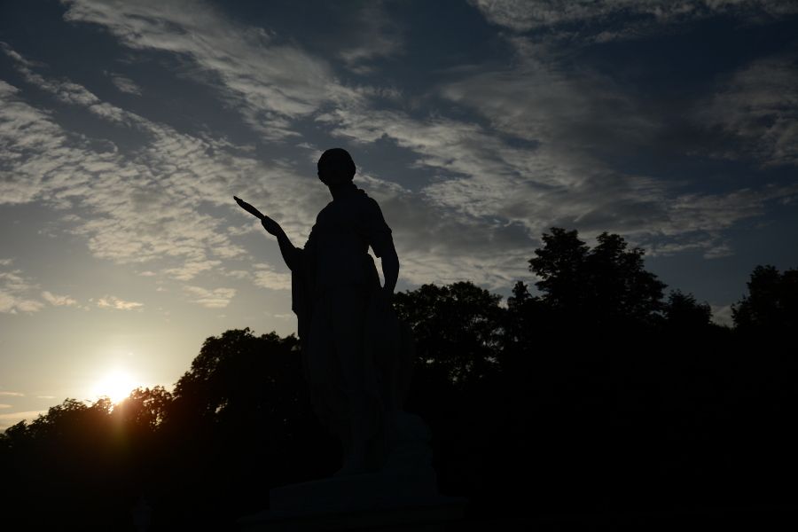 Statue at sunset at Nymphenburg Park Garden in Munich, Germany.