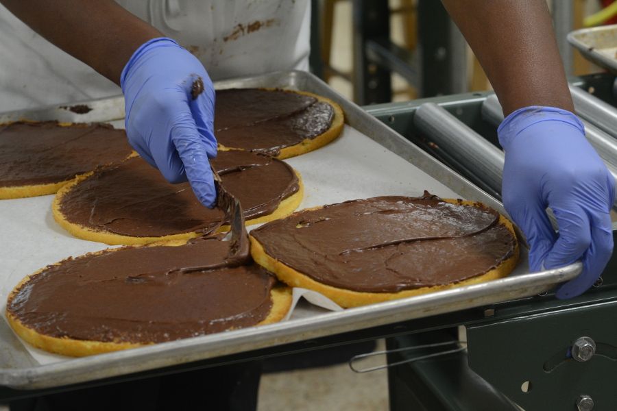 Spreading frosting on cake layers at the Smith Island Baking Company.