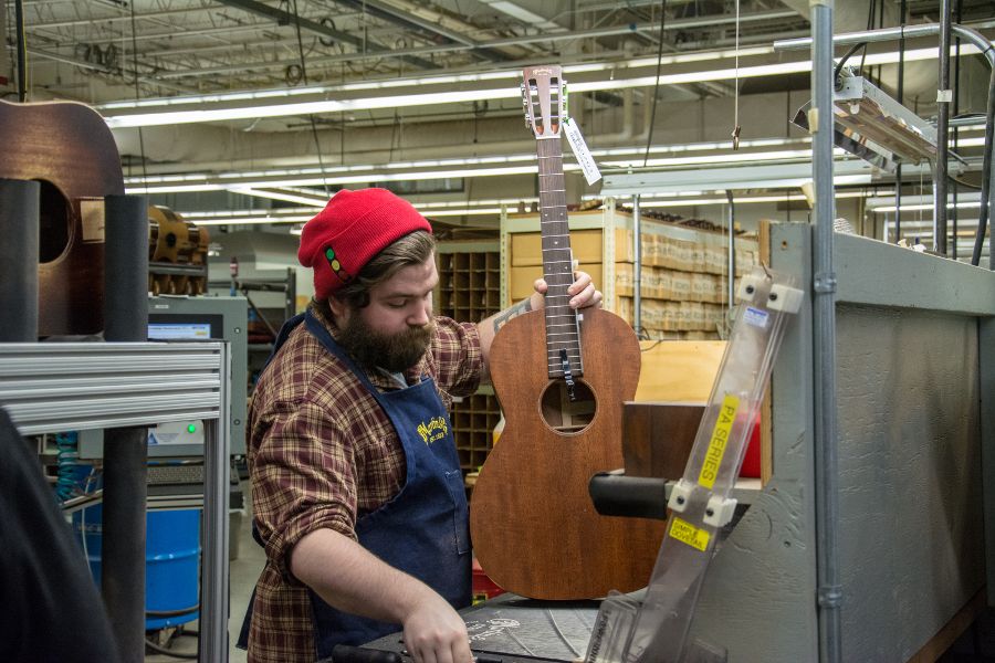 Attaching guitar necks and bodies at Martin Guitar factory.