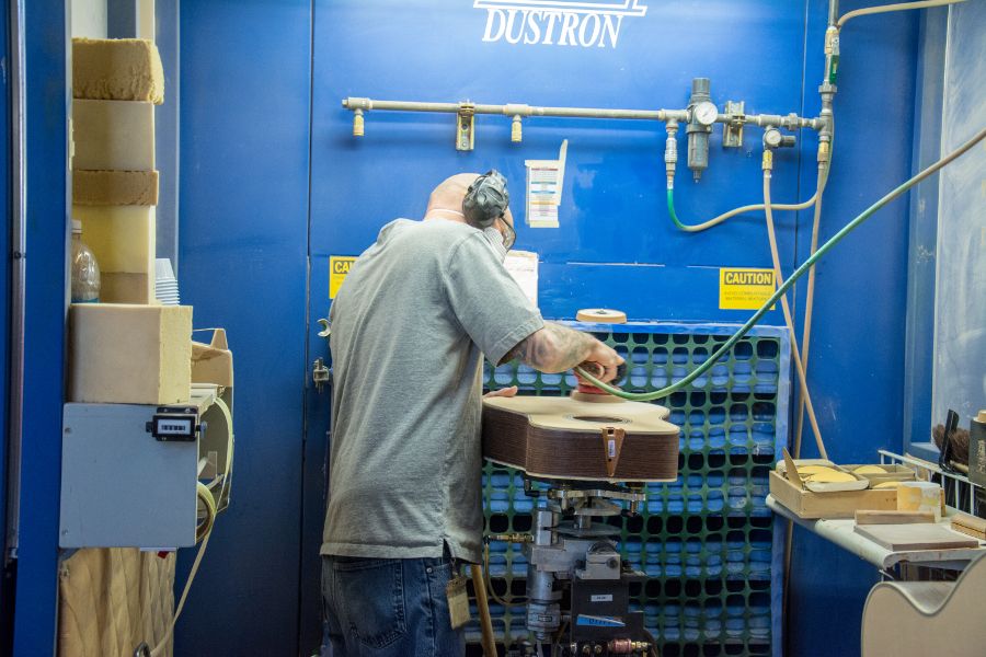 Finishing a guitar at the Martin Guitar factory.