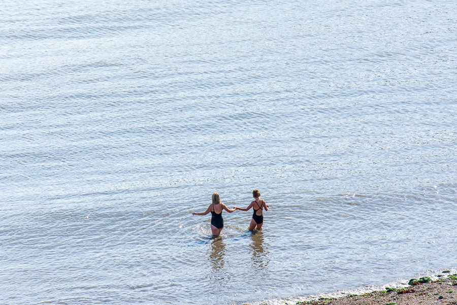 Two women go for a swim at Balscadden Bay Beach.