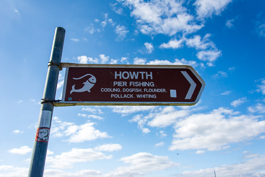 A sign points out the direction of Howth Harbour.