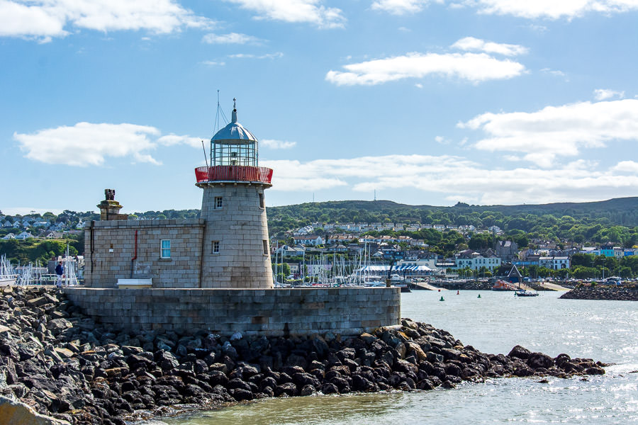 The Howth Lighthouse sits at the far point of the harbour area, jutting into the bay.