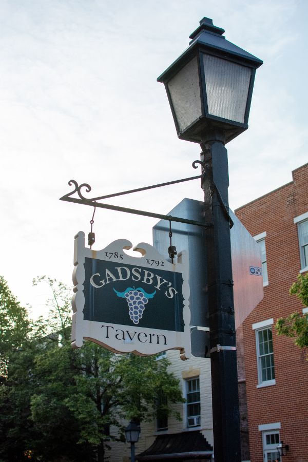 A sign post outside of Gadsby's Tavern in Old Town Alexandria.