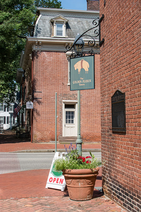 The Golden Fleece Tavern sign hangs on a corner of The Green.