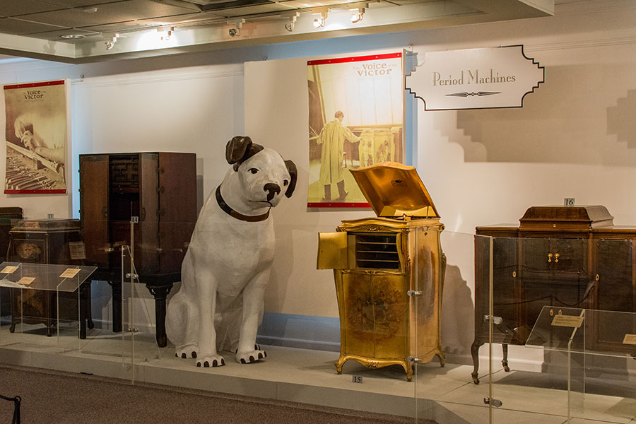 Exhibits upstairs at the Johnson Victrola Museum, including a golden Victrola and a larger than life Nipper statue.