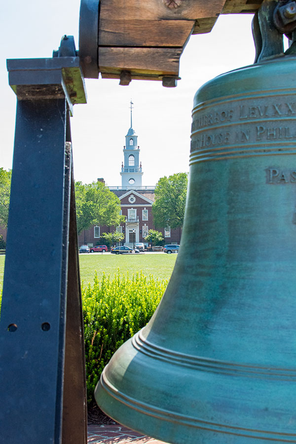 Delaware's Legislative Hall seen through a replica of the Liberty Bell.