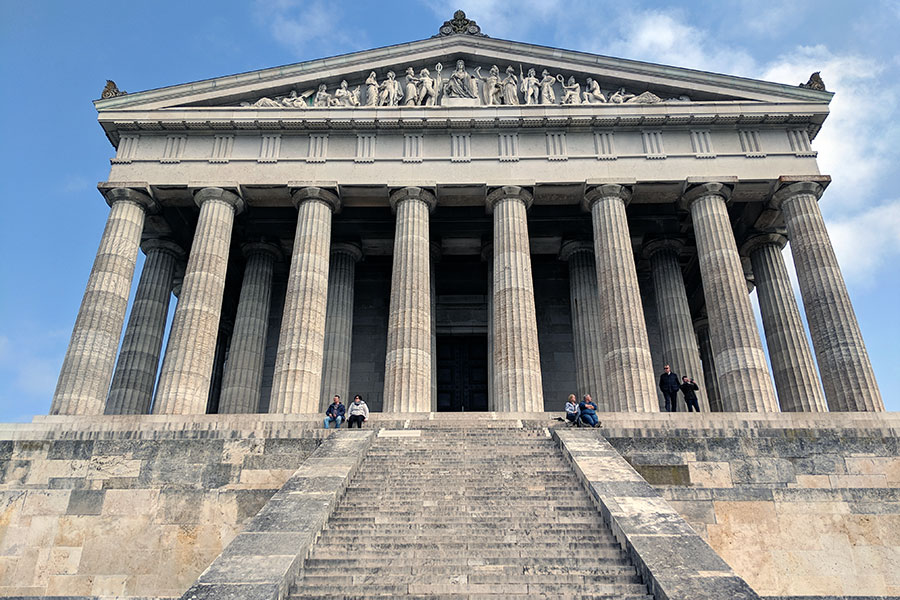 People sit on the steps in front of Walhalla, as it overlooks the Danube in Donaustauf, near Regensburg, Germany.