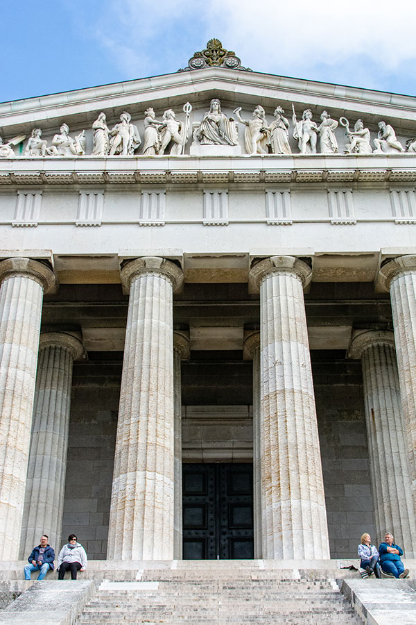 People sit on the steps in front of Walhalla.