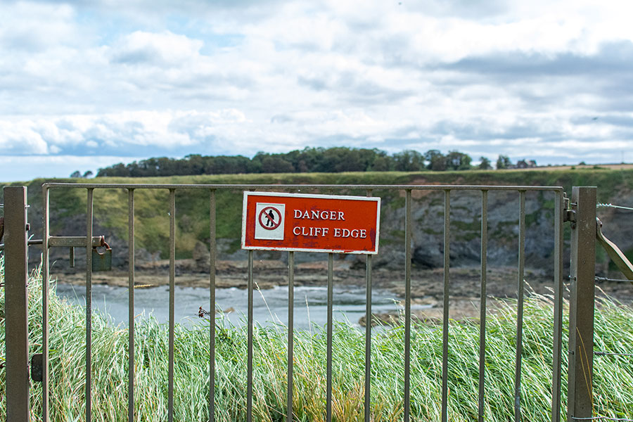 A sign warns visitors of the dangerous cliff edge.