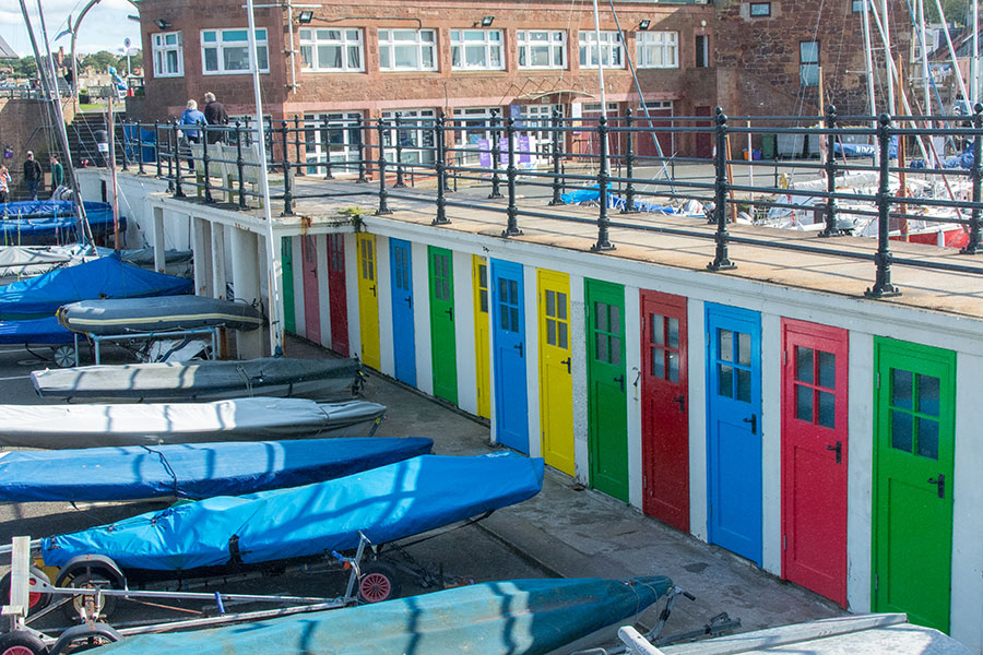 Brightly colored doors line the wall at the North Berwick Yacht Club in Scotland.