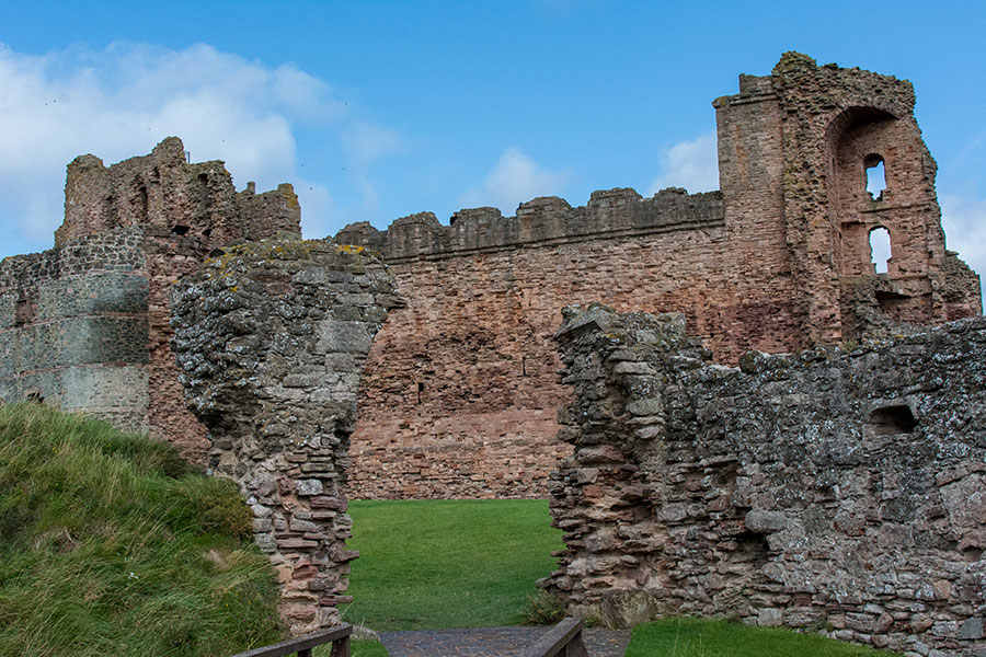 A walkway draws visitors into the ruins of Tantallon Castle.