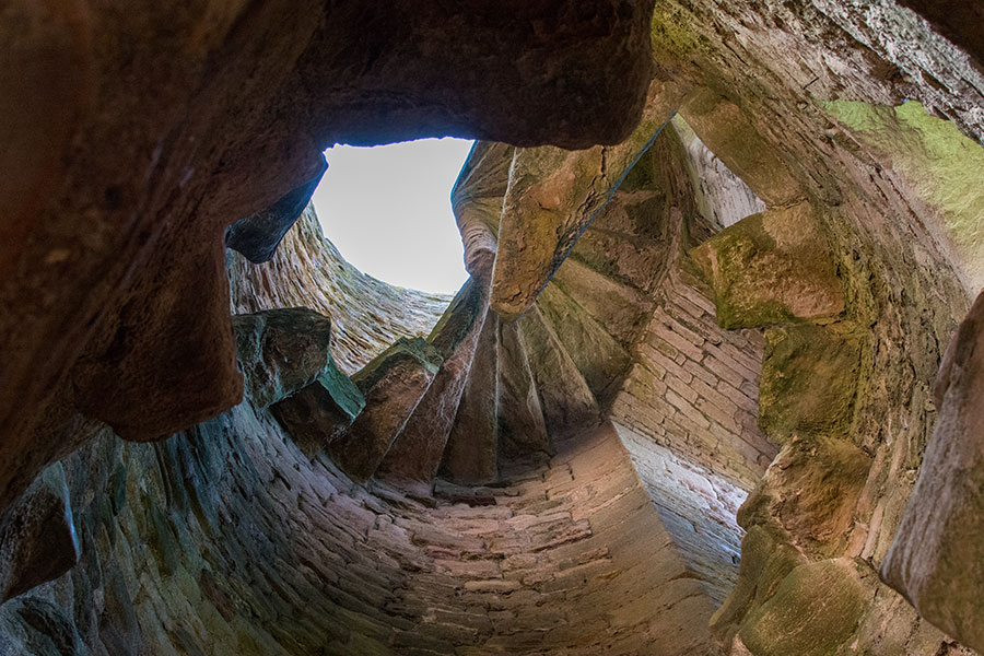 Looking up at the ruins of a spiral staircase in Tantallon Castle.