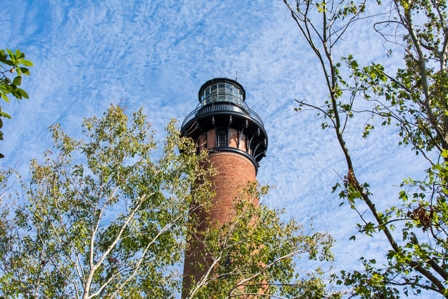 Currituck Beach Lighthouse peeks out from behind the trees.