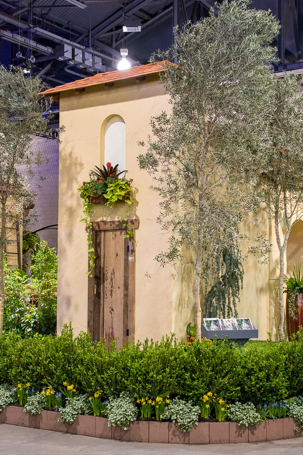 A Riviera feel with plants surrounding architectural buildings.