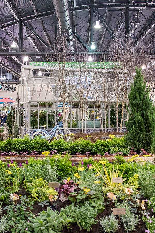 A greenhouse set amongst the plants.