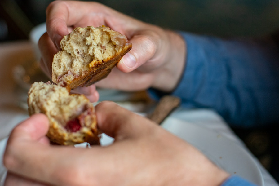 Breaking open a scone at afternoon tea.