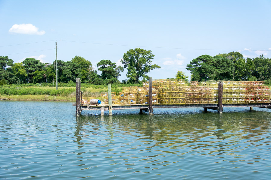 Crab traps are stacked along the dock.