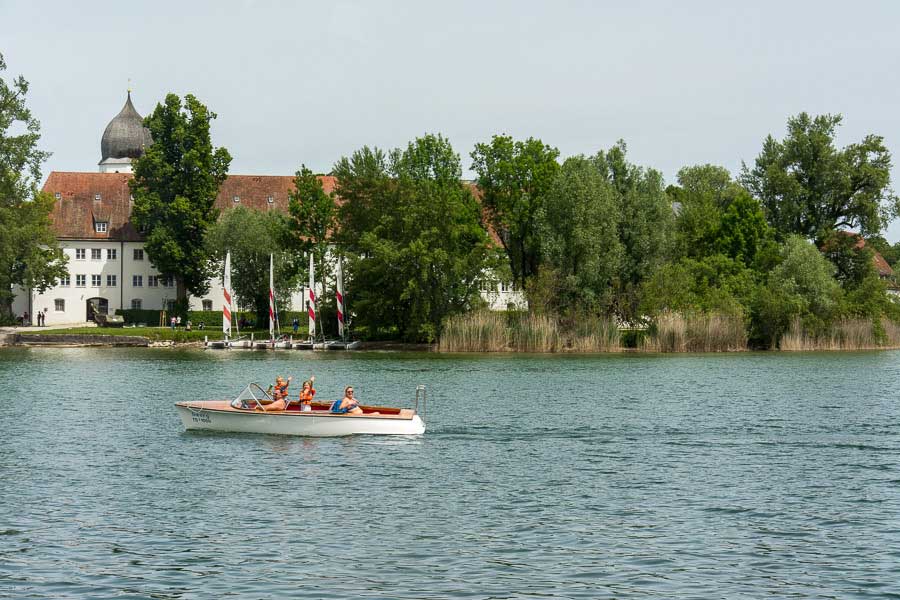 Boaters wave hello on the Chiemsee lake.