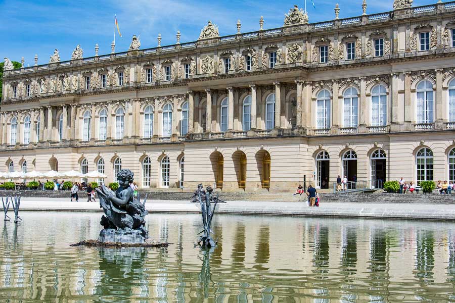 Looking across a fountain at the Herrenchiemsee New Palace.