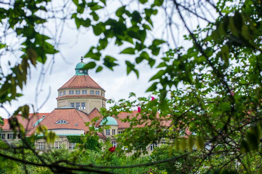 The Munich Botanical Garden hall seen through the trees.