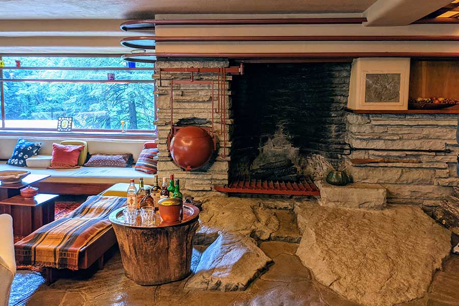 A fireplace emerges from the stones at Fallingwater.