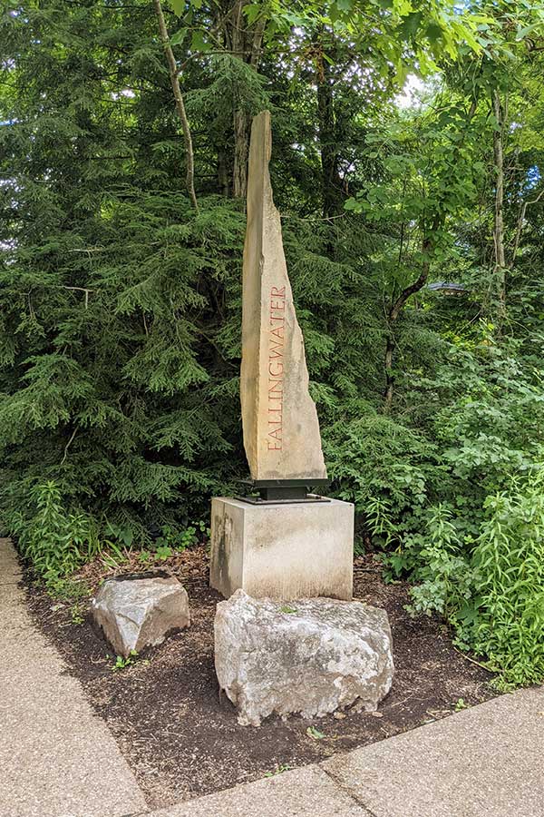 A stone marks the entrance to Fallingwater.