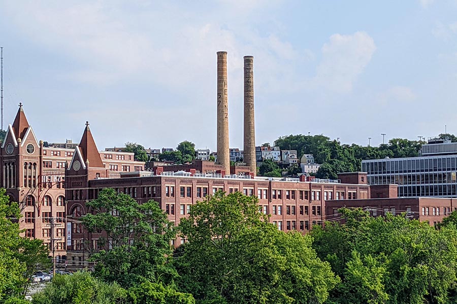 Two chimneys soar to the sky from the one time HJ Heinz Company complex of brick buildings.