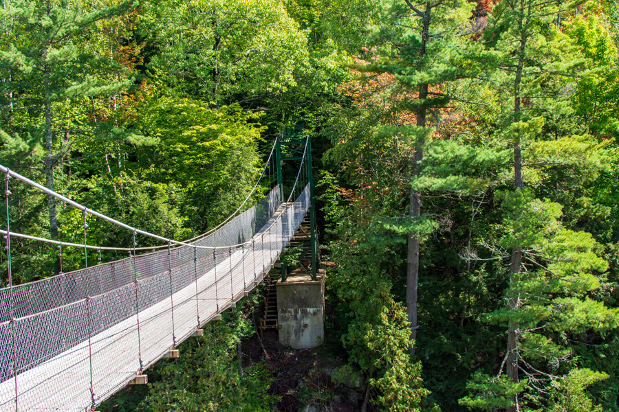 A suspension bridge leads travelers over the Canyon Sainte-Anne.