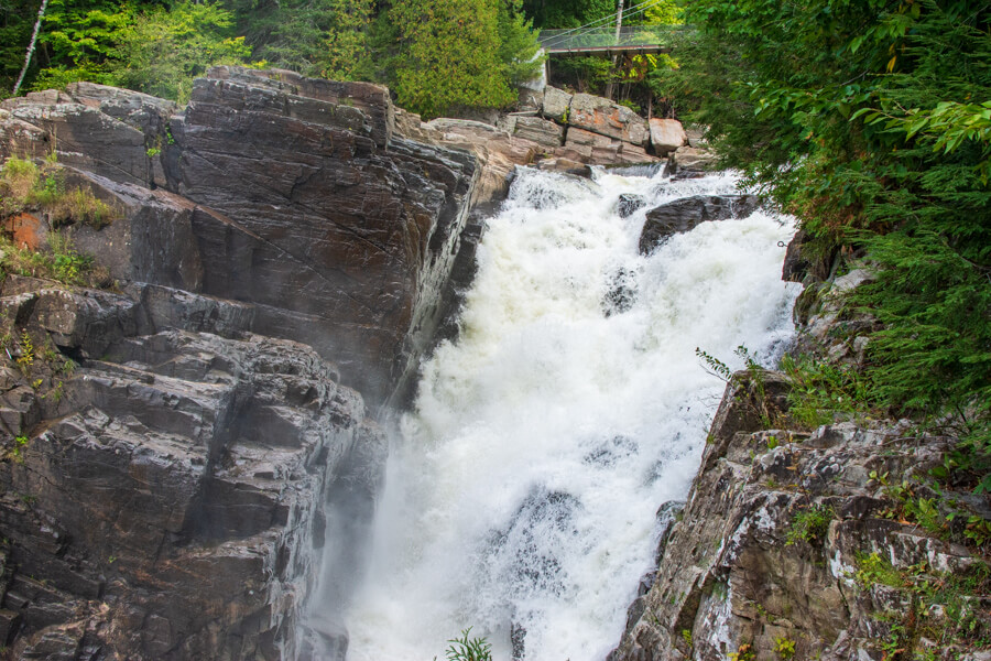 Water rushes over the Quebec waterfall.