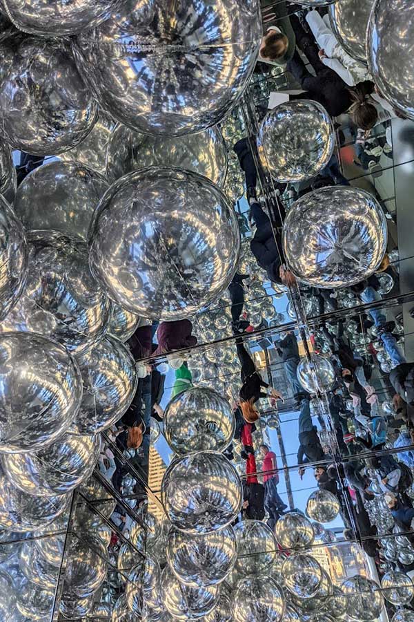 Chrome balloons collect against the mirrored walls of Summit One Vanderbilt.