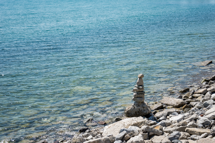 Stones are carefully stacked on the edge of Lake Ontario.