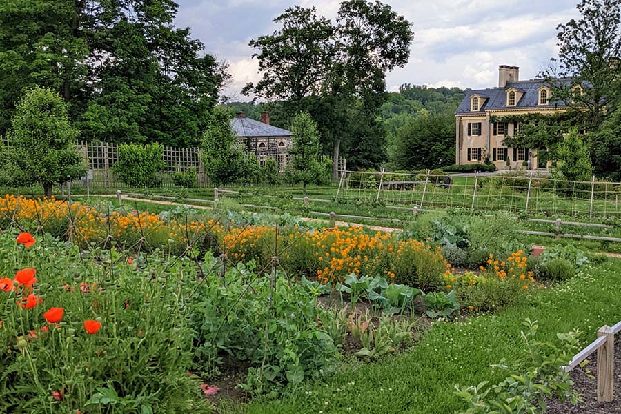 The GeoThe du Pont garden laid out before the family home, Eleutherian Mills.rgian-style Eleutherian Mills is the first du Pont family home in America.