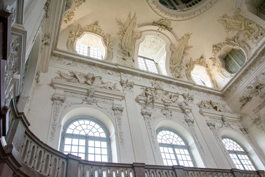 The walls of the grand stairway are ornately decorated in the Bavarian palace of Schloss Schleissheim.