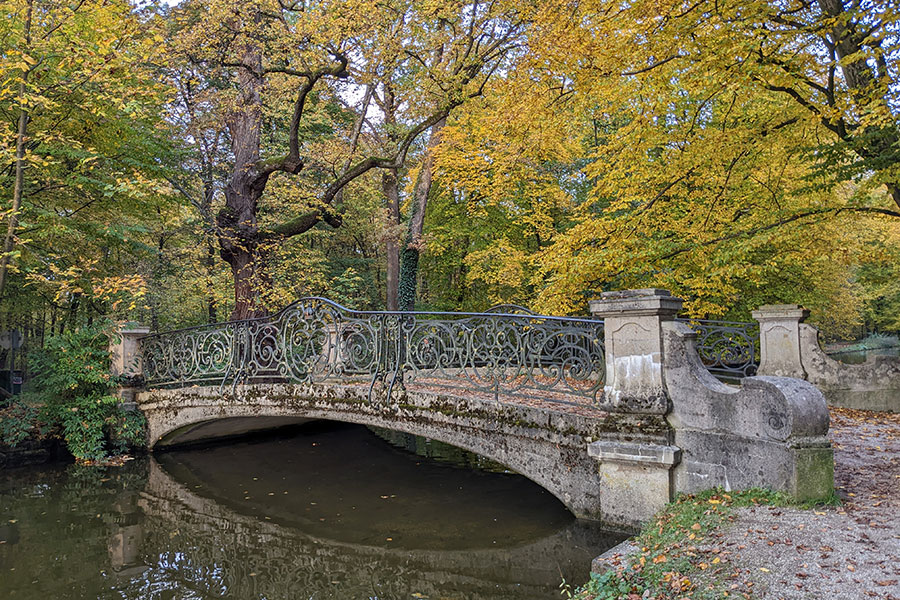 Colorful leaves frame a bridge for Bavaria in the autumn.