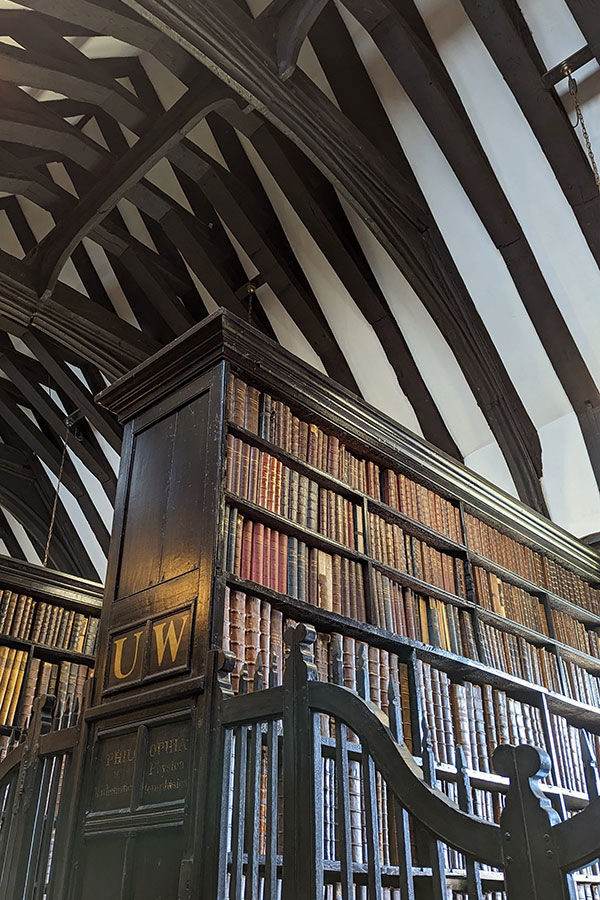 The book shelves at Chetham's Library stand beneath vaulted ceilings.