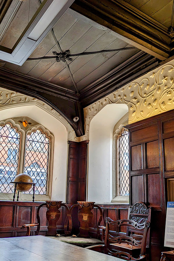 The Audit Room at Chetham's Library in Manchester, England, is among its most impressive. The walls are lined with wood paneling and detailed plasterwork.