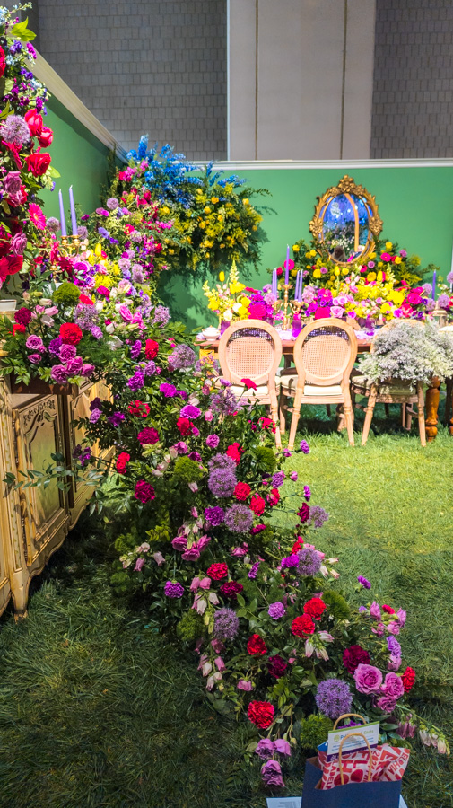 Flowers spill off the walls in the Tissarose Floral display at the Philadelphia Flower Show 2024.