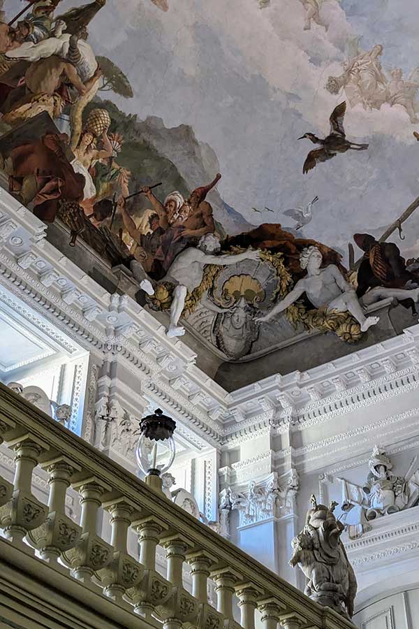 Legs dangle out of the ceiling frescoes at the Würzburg Residence.