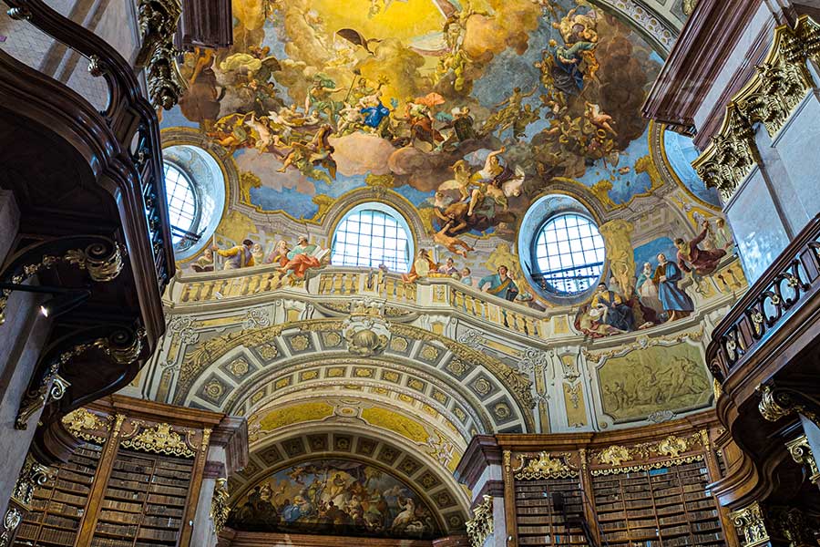 Frescoes by Court artist Daniel Gran cover the ceiling of the Austrian National Library State Hall in Vienna, Austria.