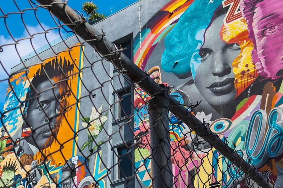 A colorful wall mural of Sidney Poitier and Judy Garland in Los Angeles adjacent to Hollywood Boulevard.