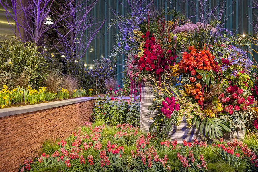 3D-printed concrete planters are full of lush flower arrangements in the PHS entrance garden.